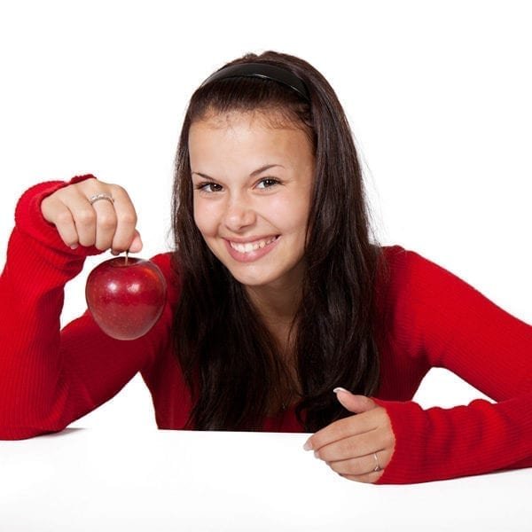 The image shows woman holding an apple, promoting a healthy and active lifestyle.