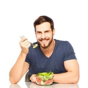 A boy enjoying a nutritious bowl of fresh vegetables.